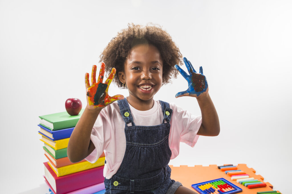 girl with colored hands with paint studio