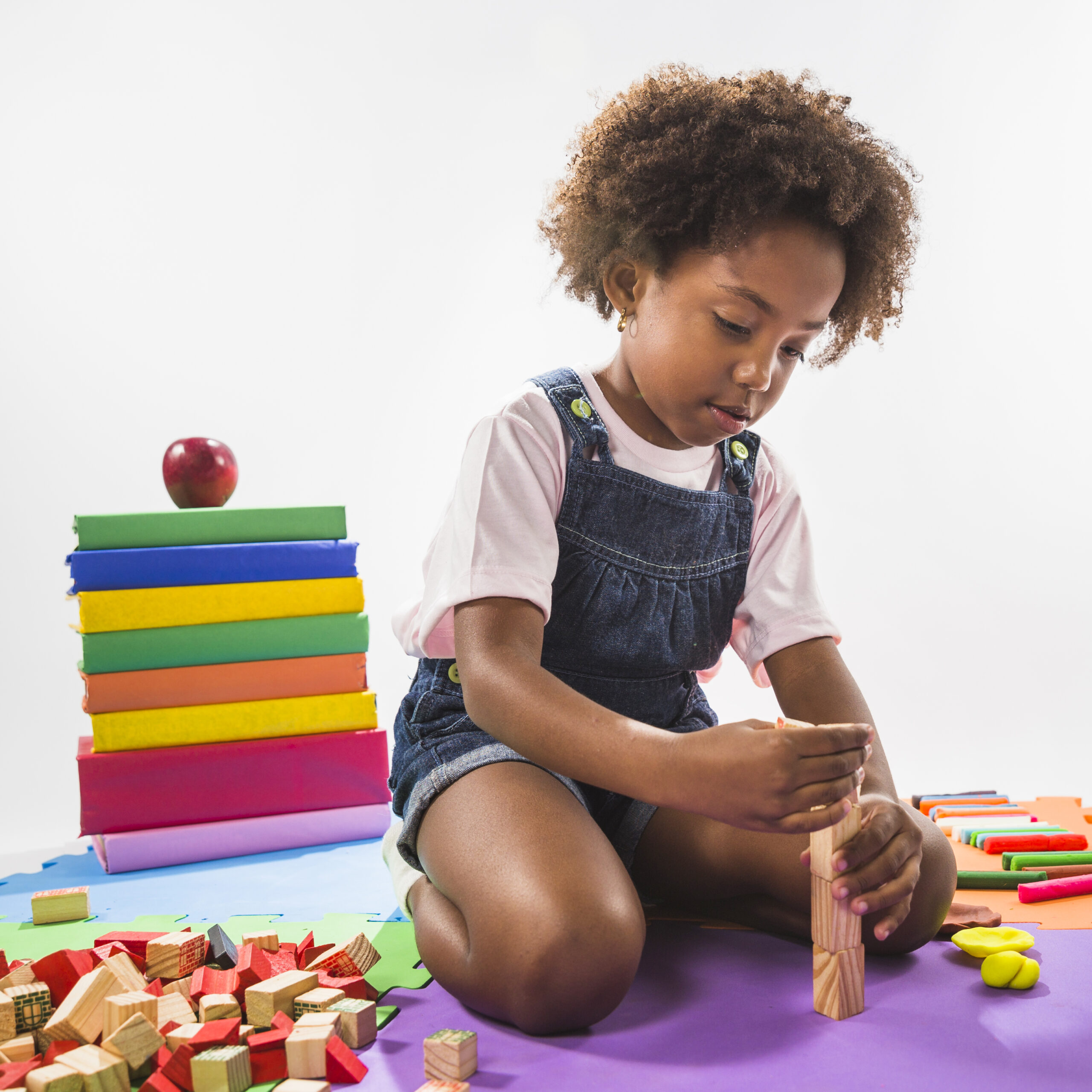 kid playing with cubes play mat studio
